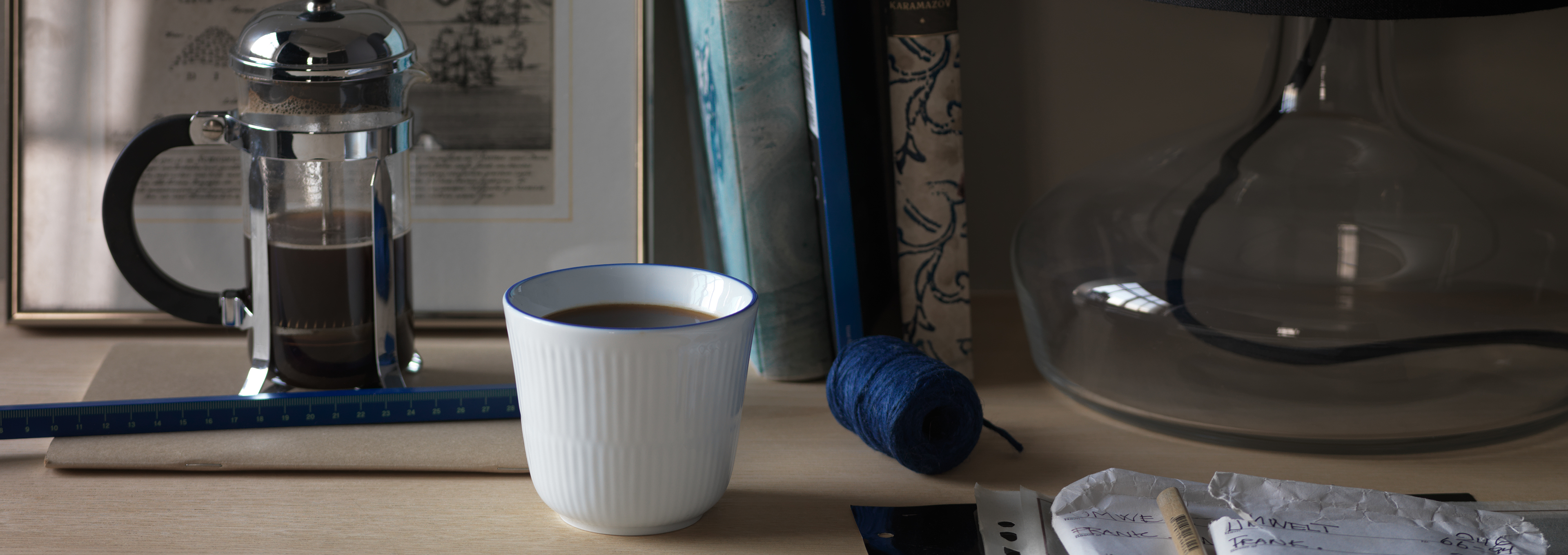 A Blueline Thermal mug with coffee on a desk